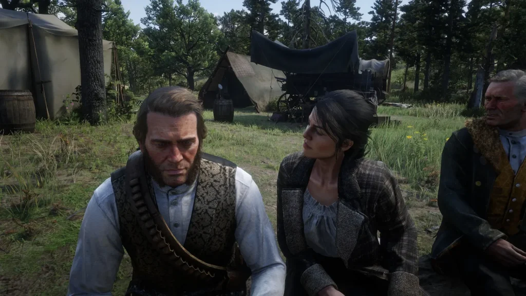 Arthur Morgan sitting with gang members at camp showing emotional depth in Red Dead Redemption 2