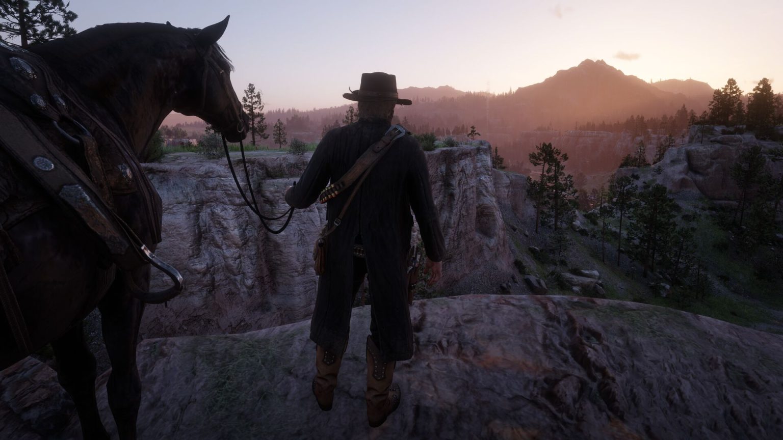 Arthur Morgan standing beside his black horse overlooking a sunset valley in Red Dead Redemption 2.